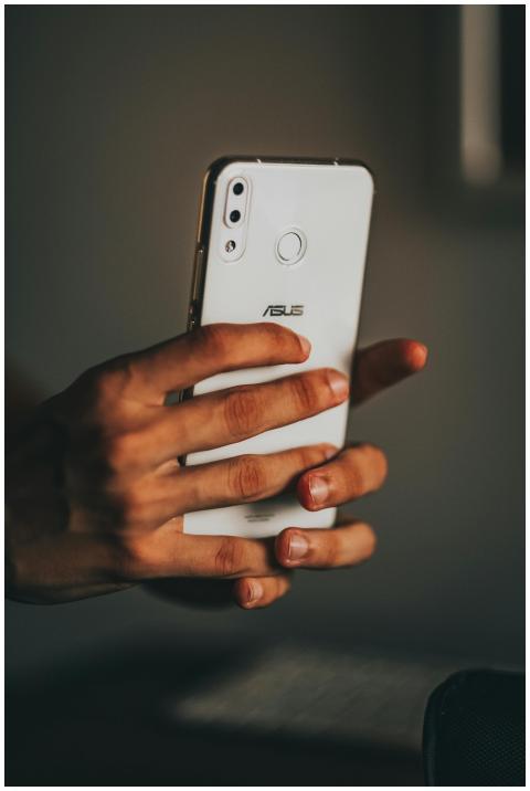 Close-up of hands holding a smartphone, focusing o