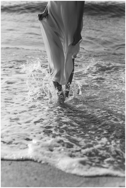 A grayscale image of an elegant woman walking thro