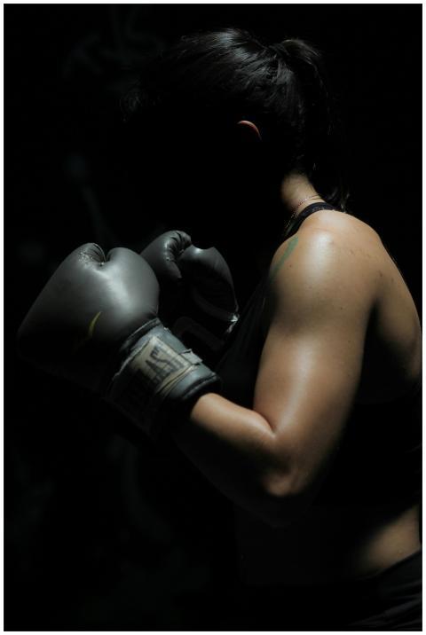 A powerful image of a female boxer showcasing stre