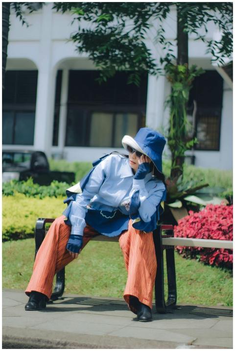 Fashionably dressed woman in unique outfit enjoyin