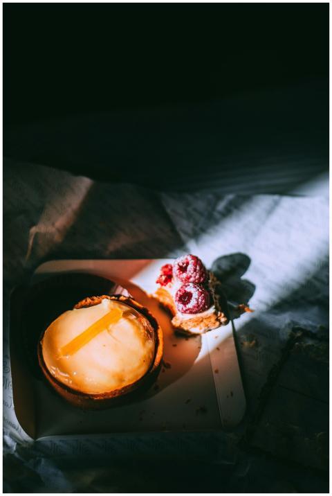 A delectable cheesecake topped with fresh raspberr