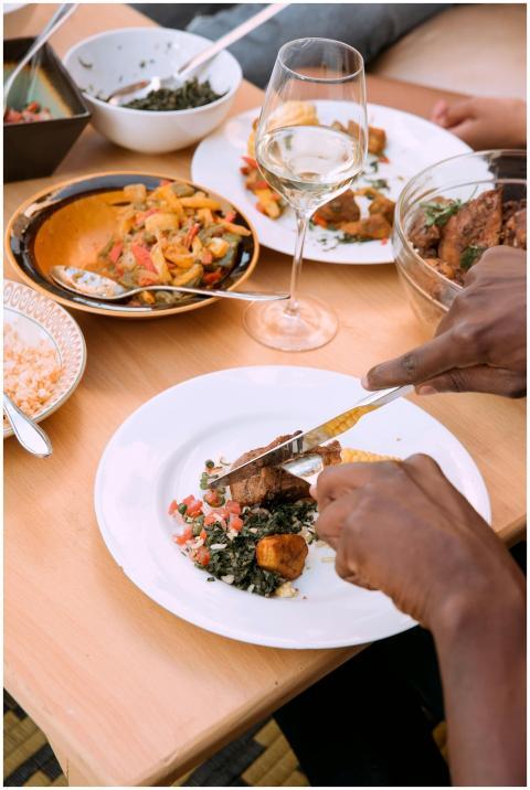 Elegant dining setup with diverse dishes and a gla