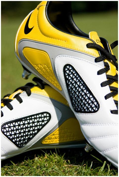 High-quality image of yellow and white soccer shoe