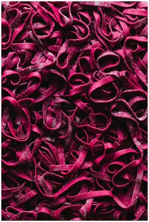 Flat lay shot of tangled vibrant pink ribbons for