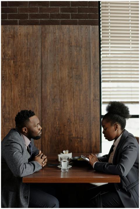 Professional coworkers discussing work over coffee