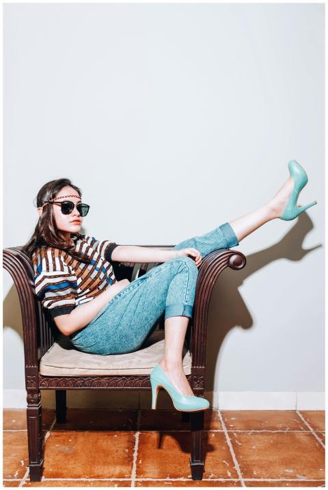 Stylish woman in sunglasses lounging on a vintage