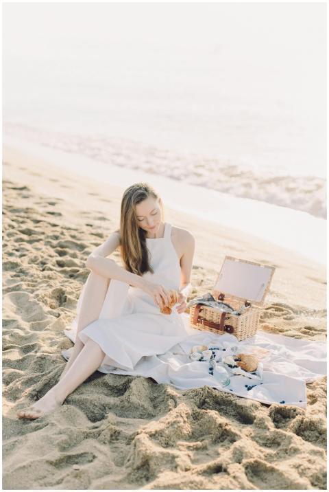 Woman enjoying a relaxing picnic on a sunny beach