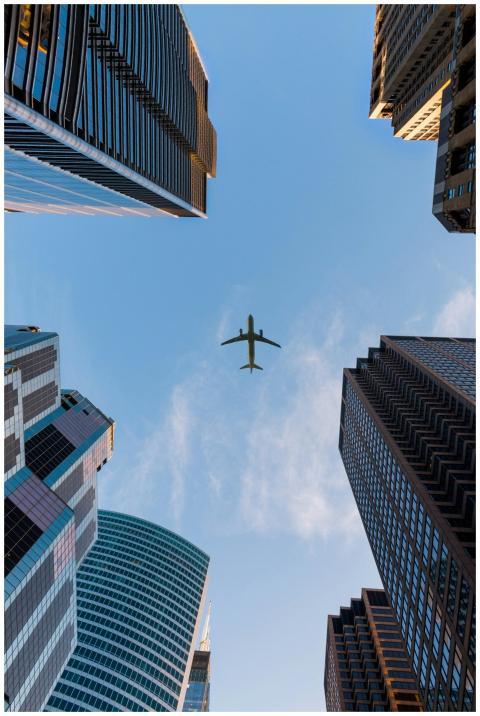 Airplane flies over Chicago's modern skyscrapers a