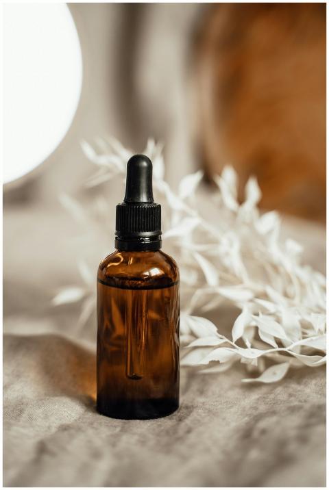 Elegant amber glass dropper bottle with organic oi