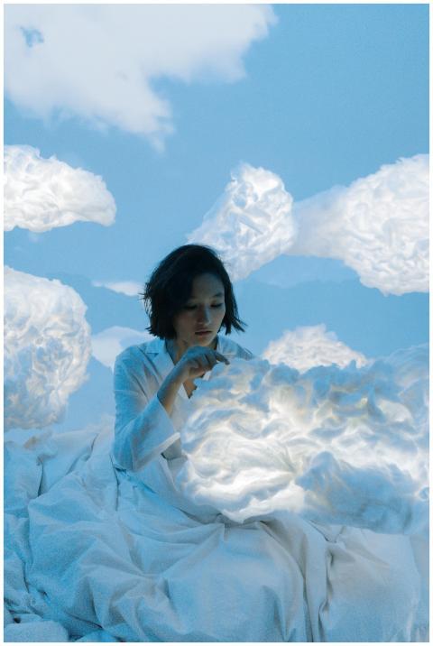 Surreal image of a woman in white surrounded by et