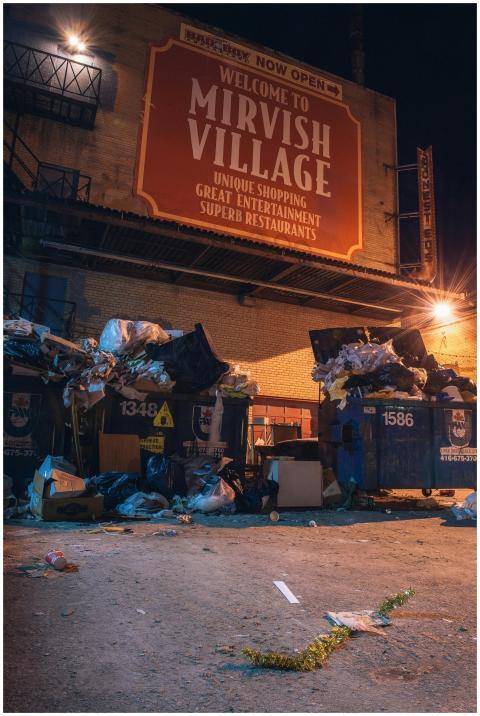 Night view of garbage bins overflowing with trash