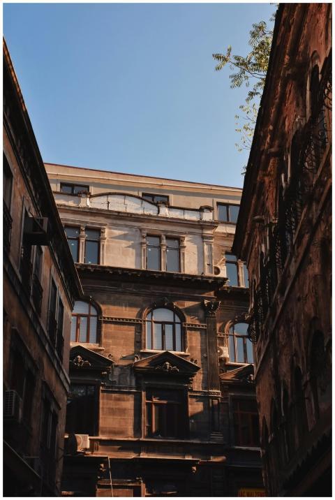 Low angle view of old residential buildings agains