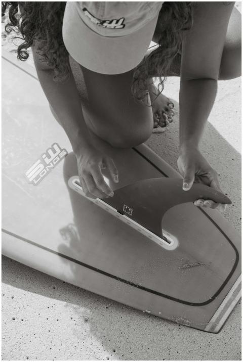 Black and white photo of a young woman attaching a