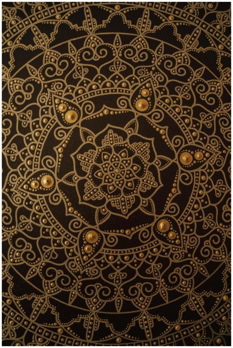 Close-up of ornate mandala design using dot painti