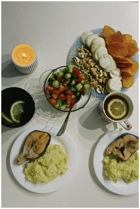 A delicious spread featuring fish, fresh salad, nu