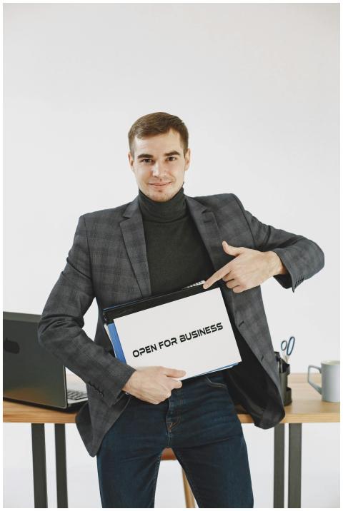 Professional man in jacket pointing to 'Open for B