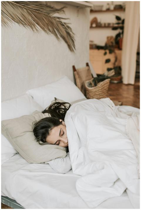 A peaceful woman sleeping comfortably in a cozy, m