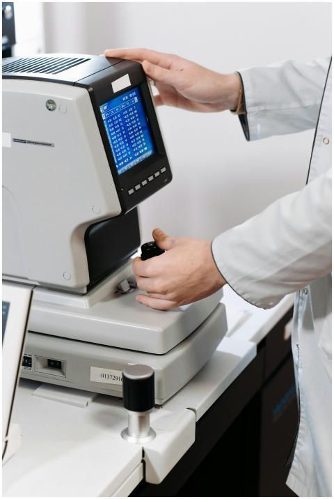 Doctor adjusts eye examination equipment for a pre