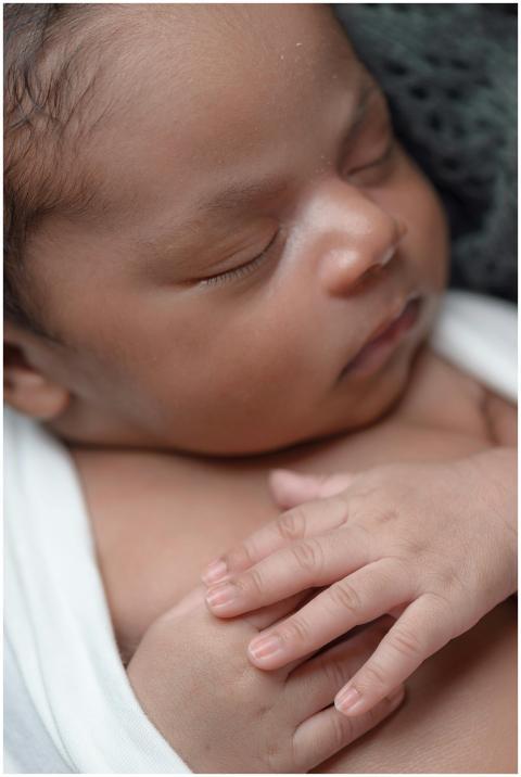 A close-up of a peaceful newborn baby sleeping wra