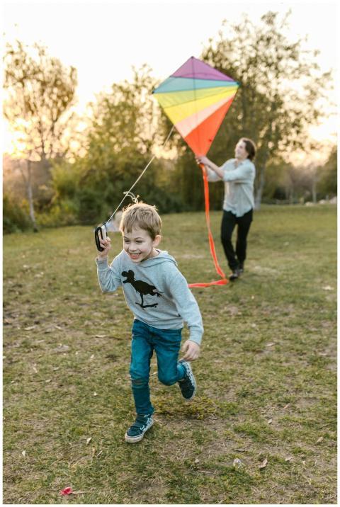 Father and son enjoying a sunny day flying a color