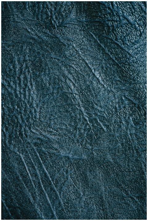 Detailed close-up of a textured blue leather surfa
