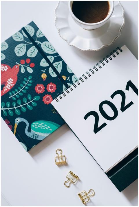 A stylish flat lay featuring a 2021 planner, coffe