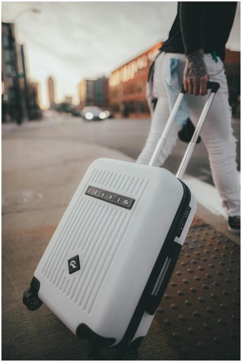 A person with tattoos walks on a city street pulli