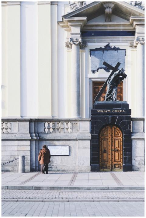 Elegant church facade with a cross-bearing sculptu
