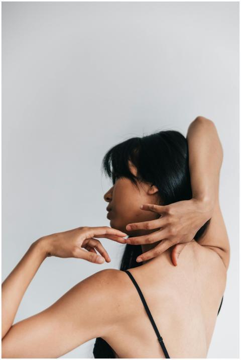 Elegant artistic portrait of a woman posing with g