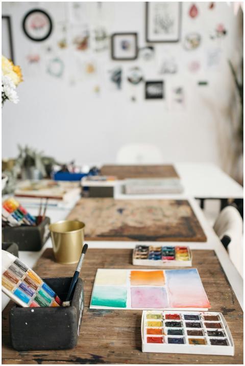 Inspiring art studio with watercolor paints and br
