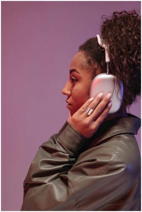 Profile of a young woman wearing headphones, enjoy