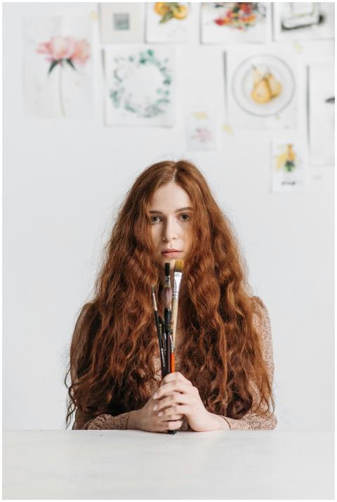Artistic portrait of a woman with long hair holdin