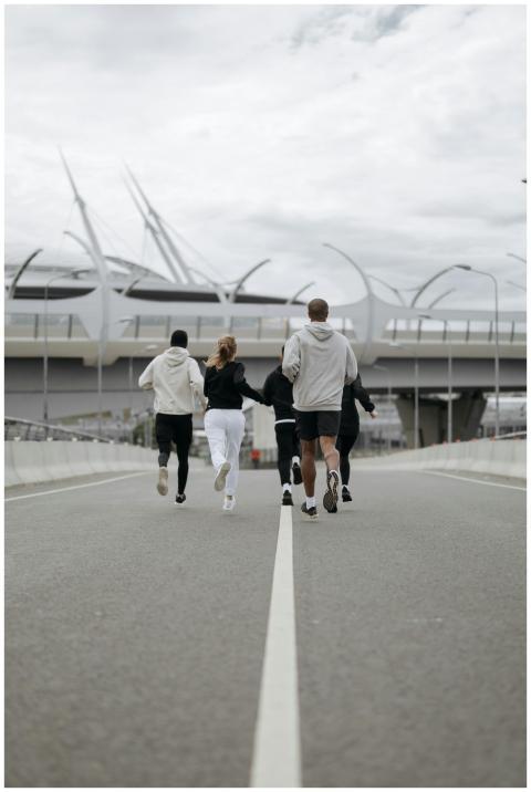 A group of people jogging together on an empty urb