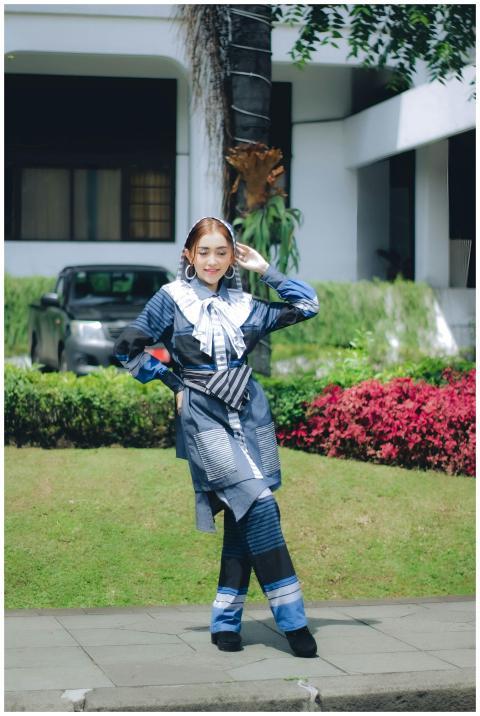Young woman in fashionable attire posing outdoors