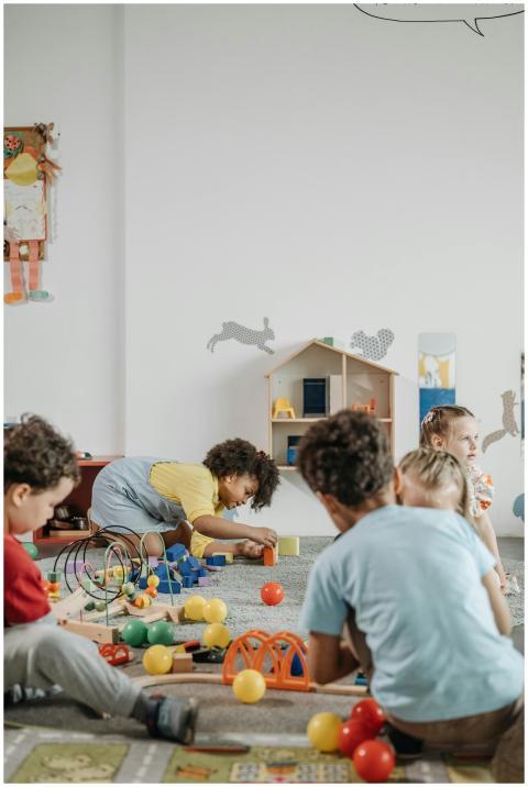 A lively group of children playing inside a colorf