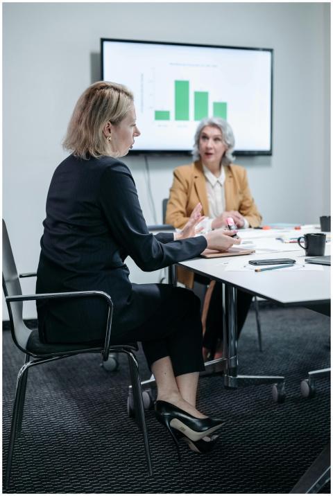 Two professional women discussing a business strat