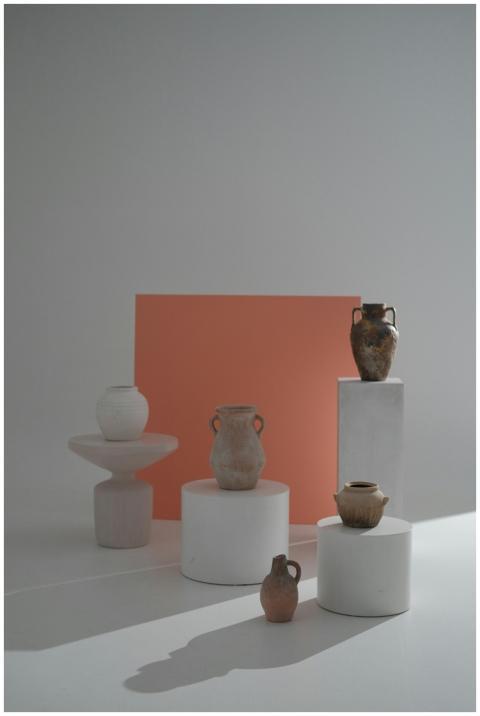 A minimalist display of various pottery vases in a