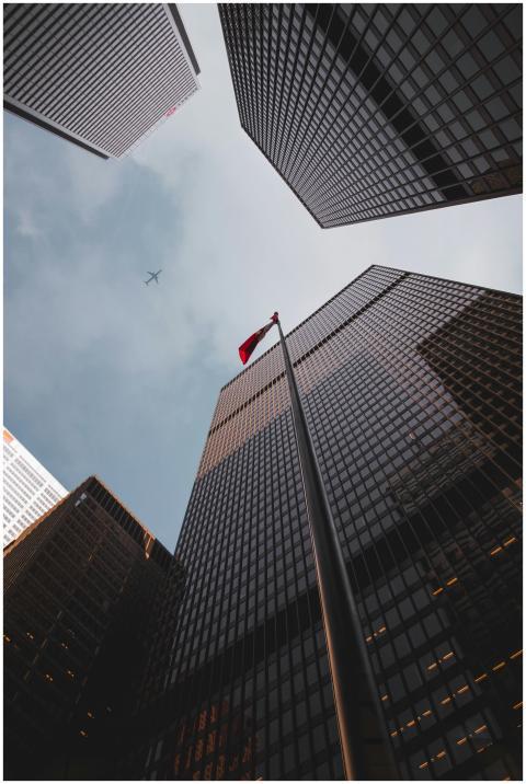 Low angle of modern skyscrapers with a Canadian fl
