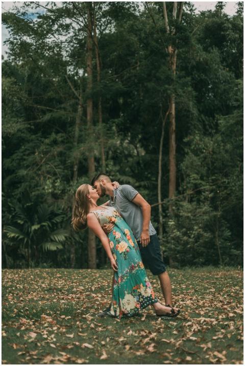A couple sharing a romantic kiss amidst the lush g