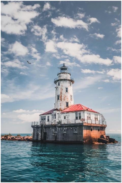 Beautiful rustic lighthouse surrounded by ocean wa