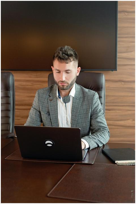 A professional businessman in a gray suit focused
