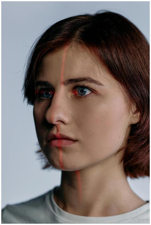 Profile of a caucasian woman with red laser lines