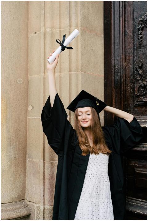 Happy graduate holding diploma. Celebrating academ
