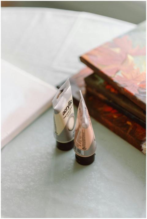 Acrylic paints and a blank canvas in a sunlit crea