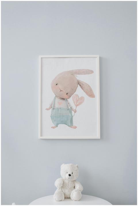Charming nursery room with bunny wall art and cudd