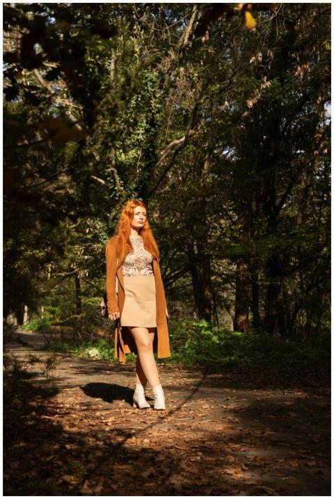 Woman with red hair enjoying a walk during fall in