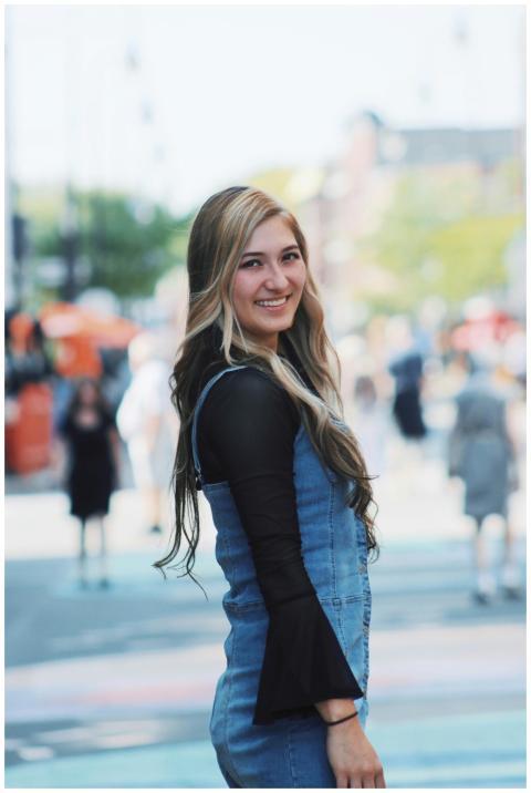 Portrait of a young woman smiling outdoors in a li