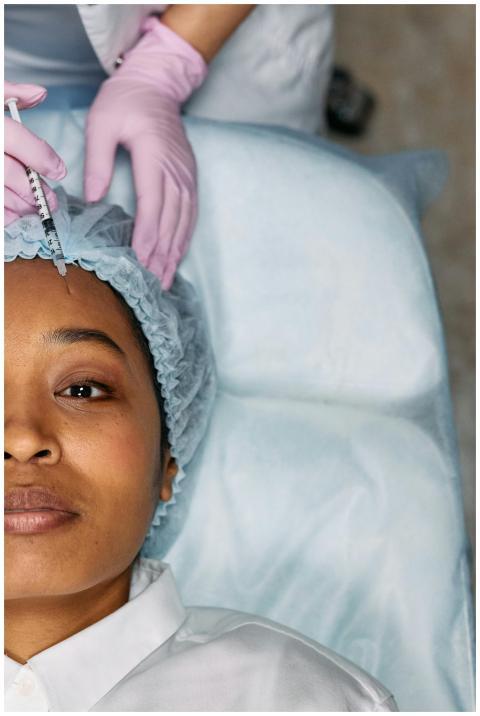 A woman receiving a cosmetic forehead injection in