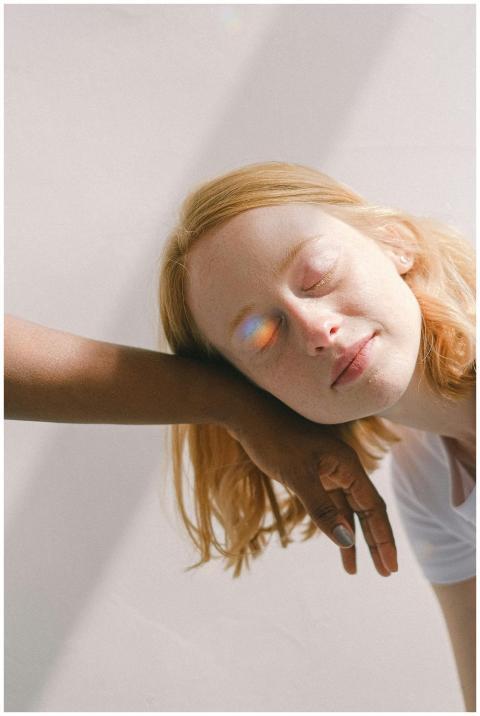 A serene interracial moment with a rainbow reflect