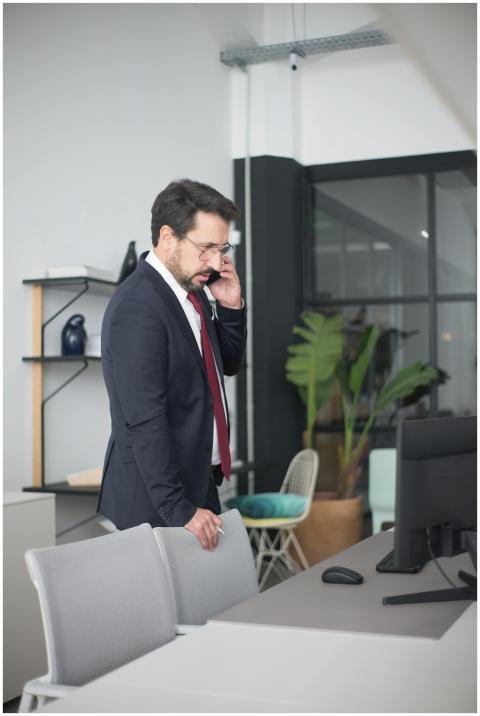 Businessman in a suit having a phone call in a con